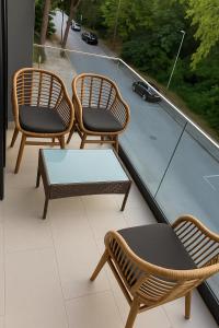 two chairs and a table on a balcony at Biser Igala in Herceg-Novi