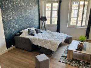 a bedroom with a bed and a couch in it at L escale in Givet