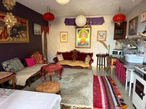 a living room with a couch and a table at sunrise flats in Mellieħa