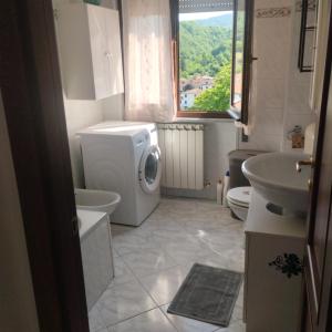 a bathroom with a washing machine and a sink at La Collina in Riccò del Golfo di Spezia +47 photos