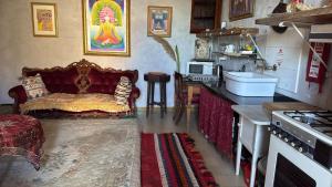 a kitchen with a couch and a table in a room at sunrise flats in Mellieħa