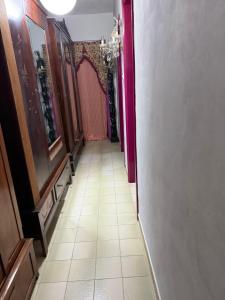 a hallway with a long corridor with pink walls at sunrise flats in Mellieħa