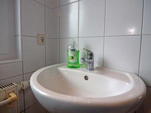 a bathroom sink with a bottle of soap on it at Ferienhaus in Rerik nahe Ostseestrand in Rerik +32 photos