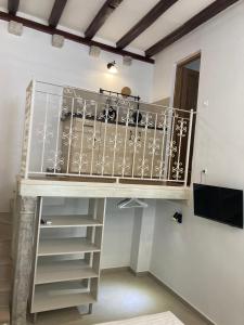 a spiral staircase in a room with a balcony at studio apartment Vicelic in Dubrovnik +23 photos