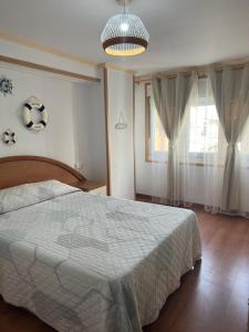 a bedroom with a bed with a soccer ball on the wall at Casa Familiar con barbacoa in Finisterre
