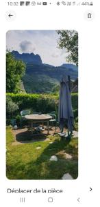 a picture of a table and an umbrella at Echarvines in Talloires