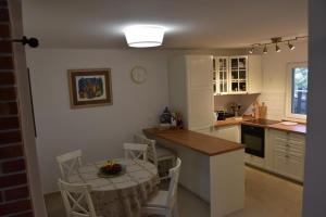 een keuken met een tafel en een tafel met stoelen bij Family House Stara Novalja in Stara Novalja
