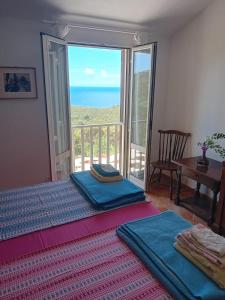 a bedroom with a bed with a view of the ocean at Casa Elisio OG Innamorata, Elba in Palazzo
