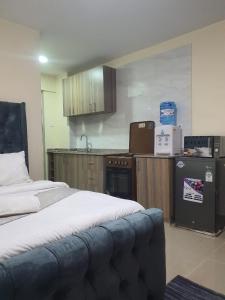 a room with a kitchen with a bed in it at Stade View Suits RH 4002 in Nairobi