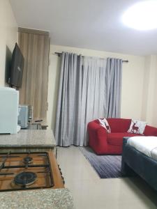a living room with a couch and a red couch at Stade View Suits RH 4002 in Nairobi