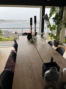 a dining room table with a view of the ocean at Panorama Byfjorden in Stavanger +23 photos
