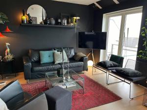 a living room with a couch and a tv at Panorama Byfjorden in Stavanger