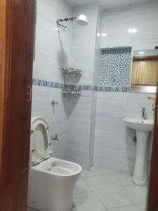 a bathroom with a toilet and a sink at Stade View Suits RH 4002 in Nairobi
