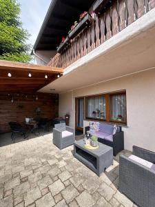 a patio with couches and a table and chairs at Ferienwohnung Lavendel in Ühlingen-Birkendorf