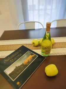 a bottle of wine and a book on a table at Estudio El Santo 2 in Salamanca +8 photos