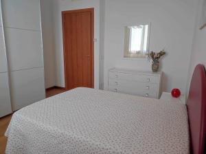 a bedroom with a bed and a dresser and a window at MARIA HOUSE for Agripolis in Legnaro