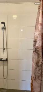 a shower in a room with a wall at Skorstensfejerens Bed & Breakfast in Bogense