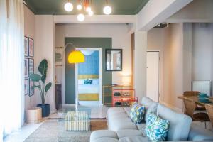 a living room with a couch and a table at Home Kong in Kavála