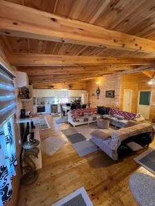 an overhead view of a large living room with wooden ceilings at Apartment 040 in Velipojë