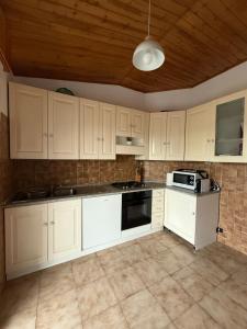 a kitchen with white cabinets and a stove top oven at Grande appartamento Stella Marina in Misano Adriatico
