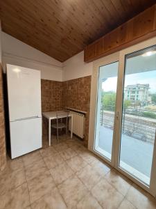 a kitchen with a white refrigerator and a table at Grande appartamento Stella Marina in Misano Adriatico +12 photos
