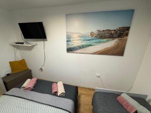 a bedroom with two beds and a picture of a beach at Blago Star Split Center in Split