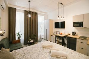 a living room with a large bed and a kitchen at Studio apartman A Zone in Đakovo