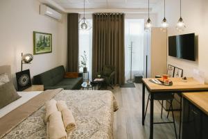 a bedroom with a large bed and a living room at Studio apartman A Zone in Đakovo