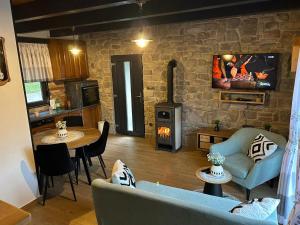 a living room with a couch and a stove at Kuća za odmor LO in Lipovlje