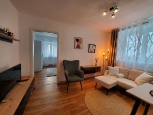 a living room with a couch and a chair at Ferienwohnung im schönen Allgäu in Kaufbeuren