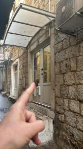 a person pointing at a building with their finger at Blago Star Split Center in Split