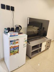 a room with a bed and a refrigerator and a table at استوديو للايجار in Quai +11 photos
