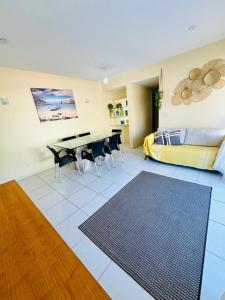 a living room with a bed and a table and chairs at Ap prainha top in Arraial do Cabo +28 photos