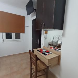a small kitchen with a small table and chairs at Porto Mesta in Mestá +12 photos