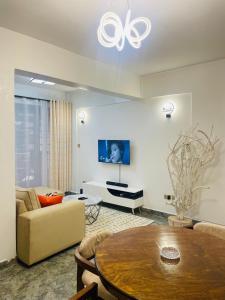 a living room with a couch and a table at 2 Bedroom All En Suite Apt with Balcony - Ruaka in Ruaka