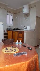 a kitchen with a table with a table cloth on it at Nekor Bay Appartement in Al Hoceïma