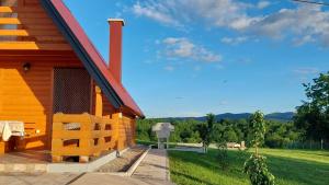 a log cabin with a porch and a view at Brvnara N&N in Laktaši