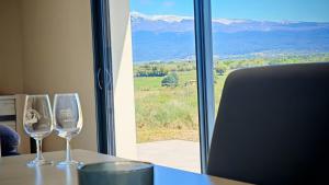 deux verres à vin assis sur une table devant une fenêtre dans l'établissement Cap sur le Ventoux, à Mormoiron