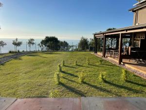 a grassy yard with a fence in the middle at Casa Natura 40 in Parghelia