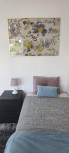 a bedroom with a bed with a painting on the wall at Albufeira New House in Albufeira +36 photos