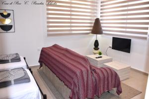 a bedroom with a bed and a table with a tv at Casa di Pino in Paradisi Square near Airport in Paradeísion