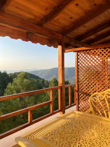 a porch with a table and a view of the mountains at Niceland İznik in Çamoluk