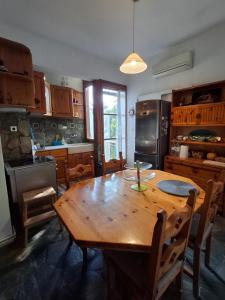 a kitchen with a wooden table and a dining room at Dream view in Eretria in Eretria