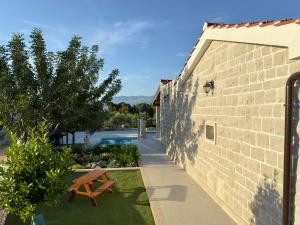 a brick building with a picnic table next to a yard at Villa Maginja in Sutivan