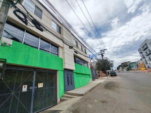 a green building on the side of a street at Departamento céntrico in Tijuana