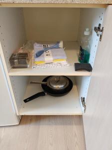 a cupboard with a shelf with a plate and a pan at Capital of LEGO Bricks - Room 02 in Billund