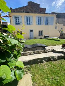 a house with a bench in front of a yard at 2 pièces élégant calme central parking sur place in Foix
