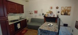 a kitchen with a stove and a couch in it at Cottanello,"La casa del sole" in Cottanello