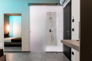a bathroom with a shower and a room with a bed at KM30rooms in Campobasso +14 photos
