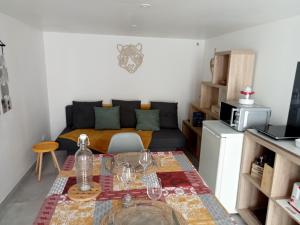 a living room with a table and a couch at le petit moulin in Montendre